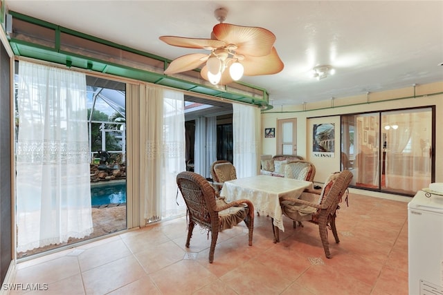 dining space featuring washer / clothes dryer, light tile patterned flooring, and ceiling fan