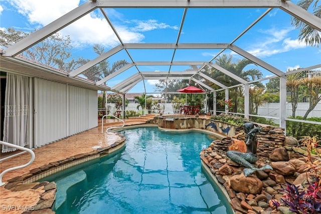 view of swimming pool featuring a lanai