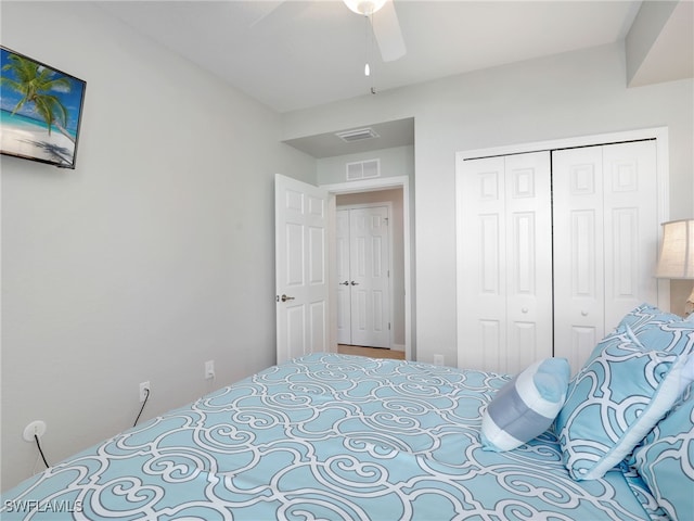 bedroom with ceiling fan and a closet