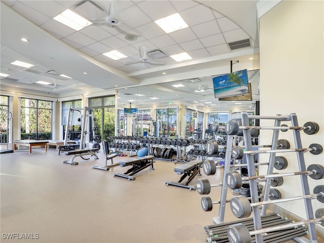 workout area featuring ceiling fan and a drop ceiling