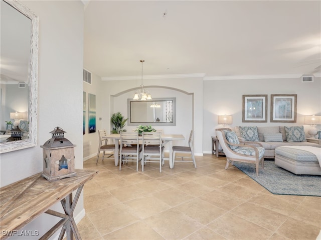 living room featuring light tile patterned flooring, crown molding, and an inviting chandelier