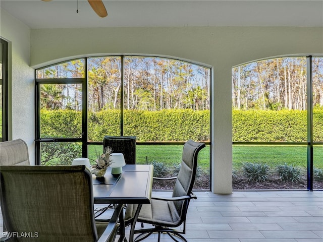 sunroom / solarium featuring ceiling fan