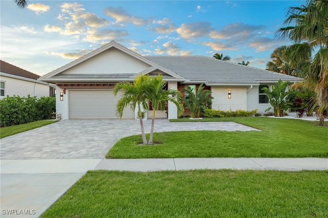 view of front of property featuring a garage and a front lawn