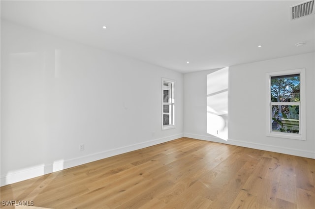 spare room featuring light wood-type flooring