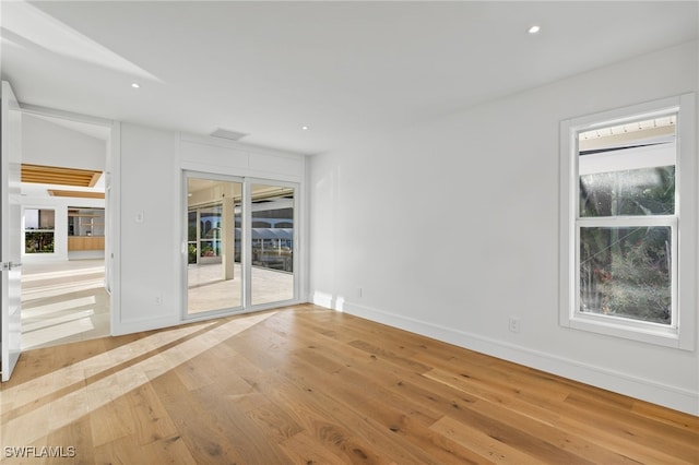 unfurnished room with light wood-type flooring