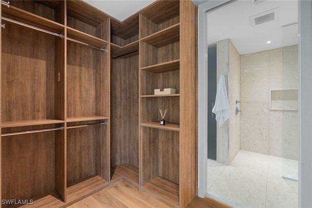 walk in closet with light wood-type flooring