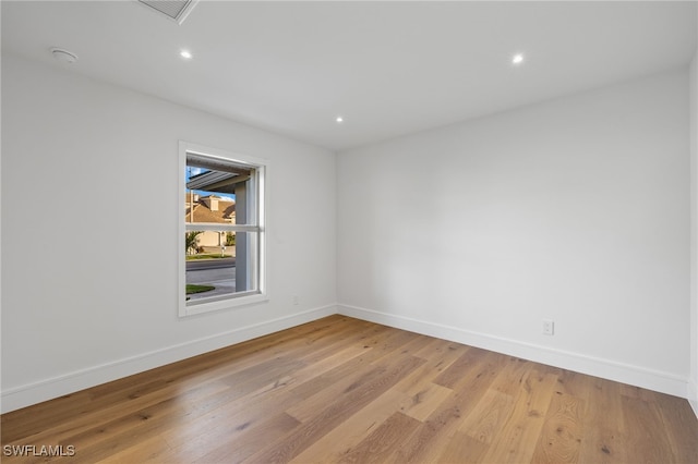 empty room with light hardwood / wood-style flooring