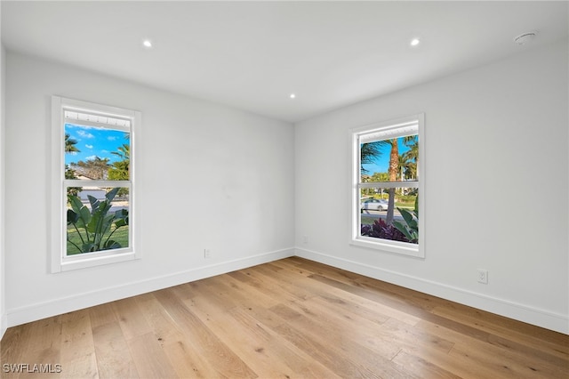 spare room featuring light hardwood / wood-style flooring