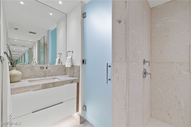 bathroom featuring vanity and an enclosed shower