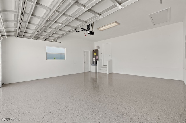 garage with electric water heater and a garage door opener