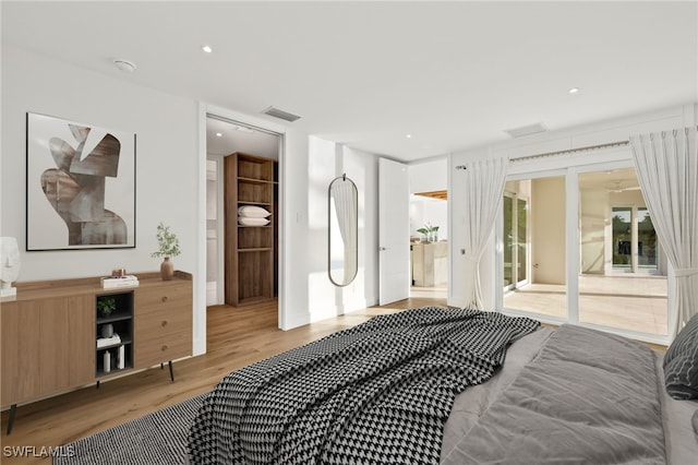 bedroom featuring light wood-type flooring and connected bathroom