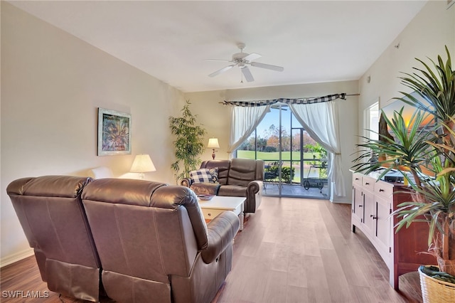 living room with light wood-type flooring and ceiling fan