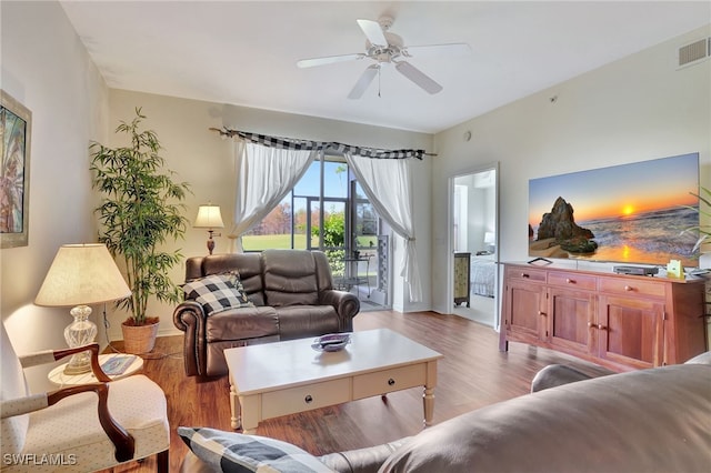 living room featuring light hardwood / wood-style flooring and ceiling fan