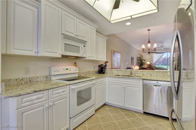 kitchen with sink, hanging light fixtures, white cabinets, ceiling fan with notable chandelier, and appliances with stainless steel finishes