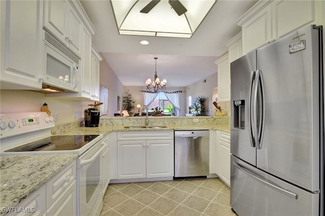 kitchen featuring appliances with stainless steel finishes, ceiling fan with notable chandelier, sink, white cabinetry, and hanging light fixtures