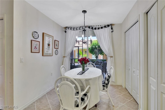 dining room with a notable chandelier and light tile patterned flooring