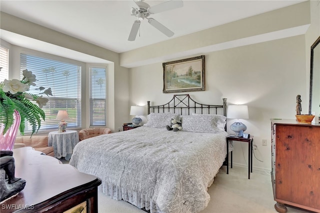 bedroom with ceiling fan and light carpet