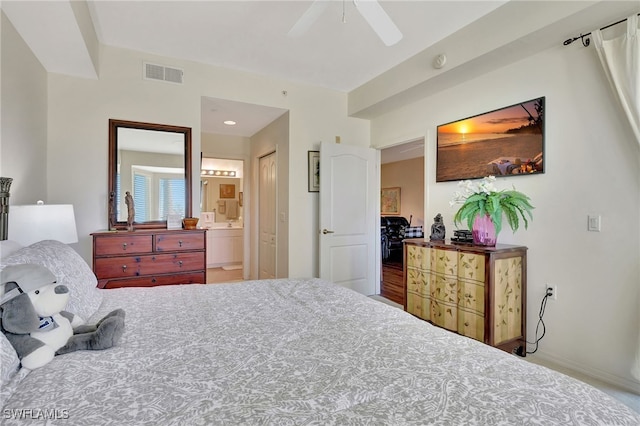 bedroom with hardwood / wood-style floors, ensuite bathroom, and ceiling fan