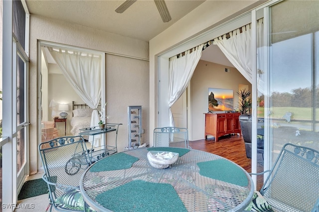 sunroom featuring ceiling fan and lofted ceiling