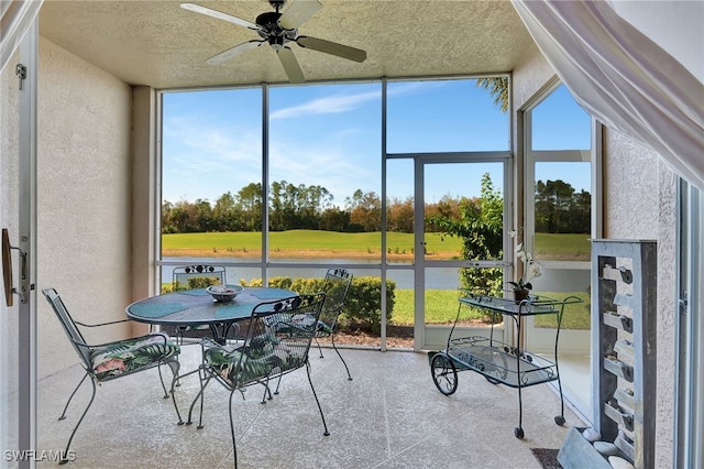 sunroom featuring ceiling fan and a healthy amount of sunlight