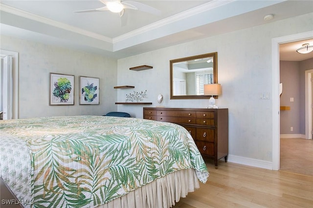 bedroom with light hardwood / wood-style flooring, ceiling fan, and crown molding