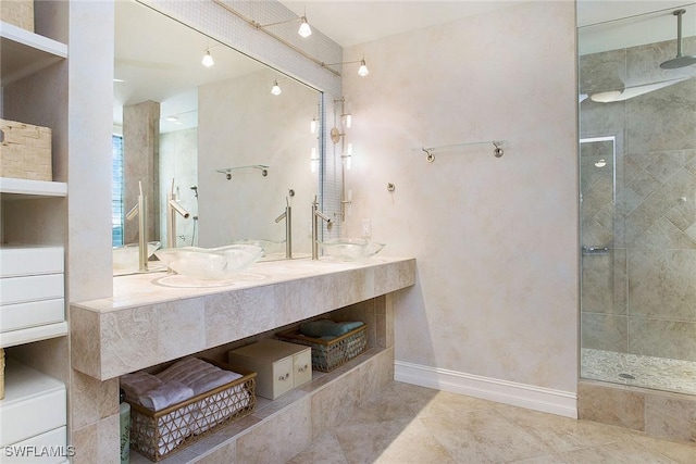 bathroom with tile patterned floors, vanity, and tiled shower