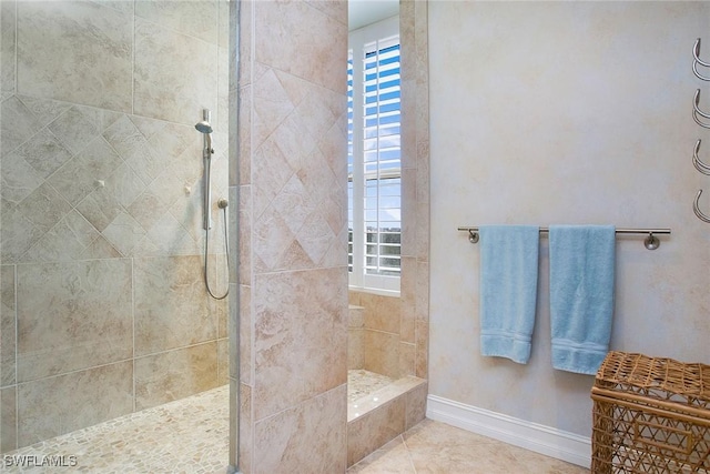 bathroom featuring tile patterned floors and tiled shower