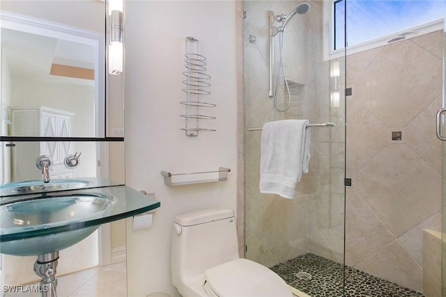 bathroom featuring tile patterned floors, toilet, and a shower with door