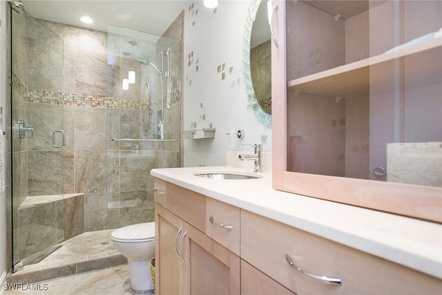 bathroom with an enclosed shower, vanity, and toilet