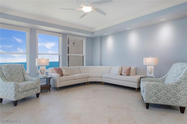 living room featuring light tile patterned floors, a water view, ceiling fan, and crown molding