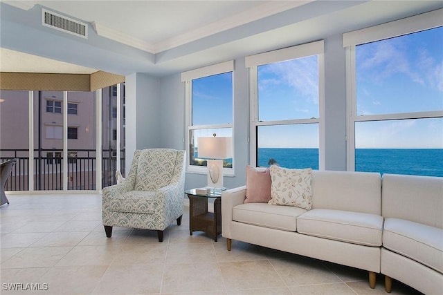 living room featuring light tile patterned floors, a water view, and crown molding