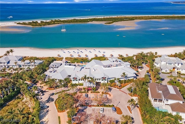 birds eye view of property with a view of the beach and a water view