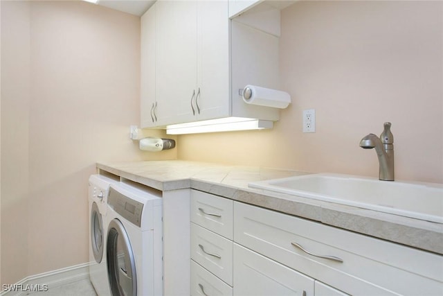 laundry room with separate washer and dryer, sink, and cabinets