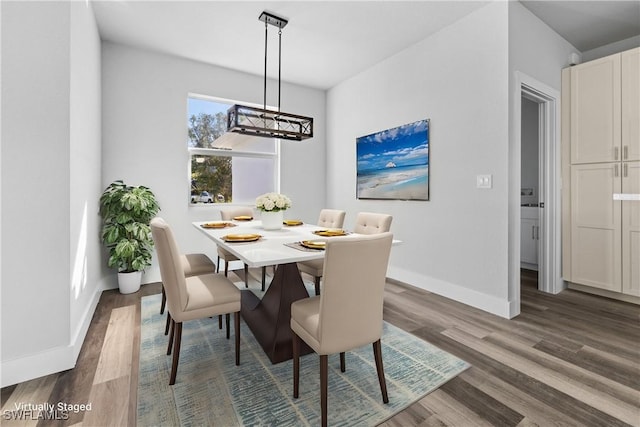 dining space featuring a chandelier and dark hardwood / wood-style floors