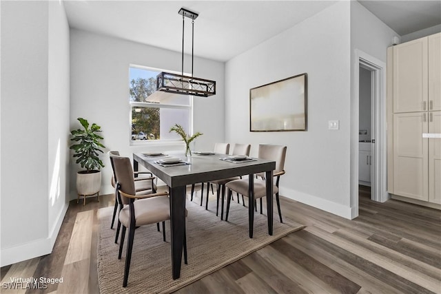 dining space featuring a chandelier and dark hardwood / wood-style floors