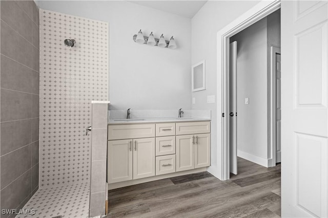 bathroom featuring wood-type flooring, walk in shower, and vanity