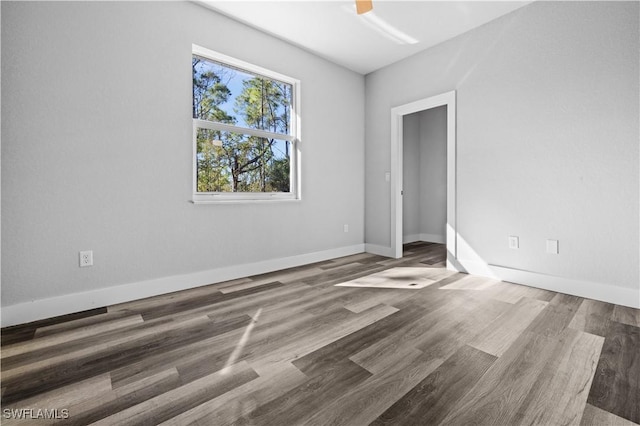 unfurnished bedroom with ceiling fan and dark hardwood / wood-style flooring