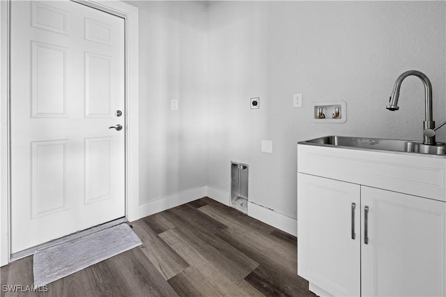 laundry room with washer hookup, sink, dark hardwood / wood-style flooring, hookup for an electric dryer, and cabinets