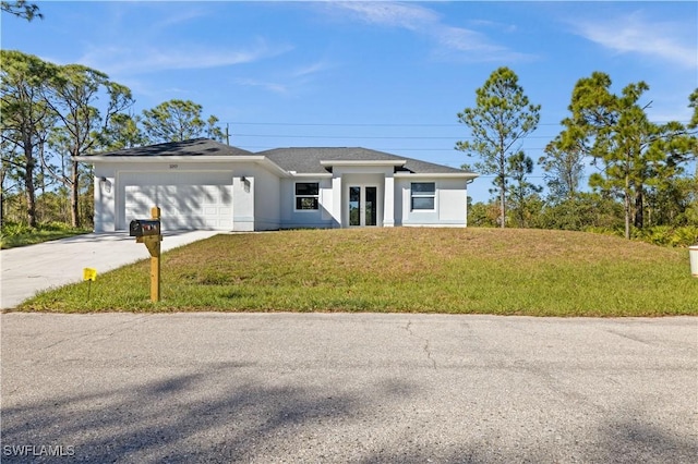 view of front of property featuring a front yard and a garage