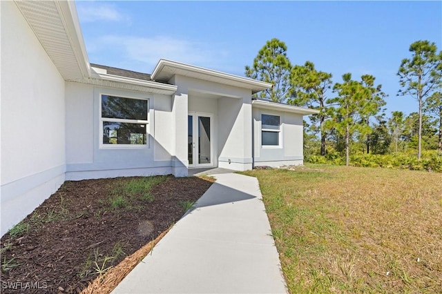 property entrance with a yard