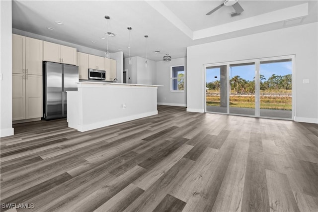 unfurnished living room featuring dark hardwood / wood-style floors and ceiling fan