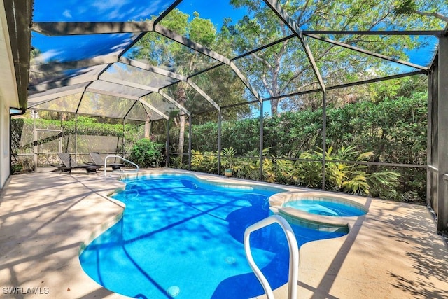 view of swimming pool featuring an in ground hot tub, a patio, and a lanai