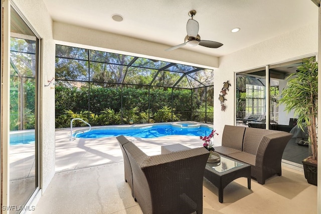 view of swimming pool featuring outdoor lounge area, ceiling fan, a lanai, a patio area, and an in ground hot tub