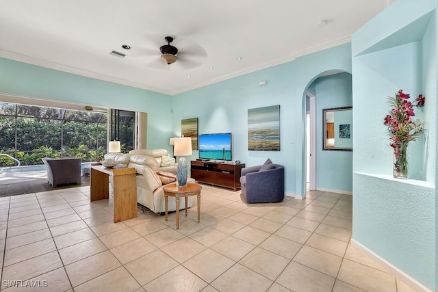 tiled living room featuring ceiling fan and ornamental molding