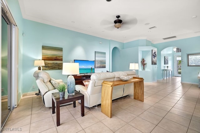 living room with ceiling fan, crown molding, and light tile patterned floors