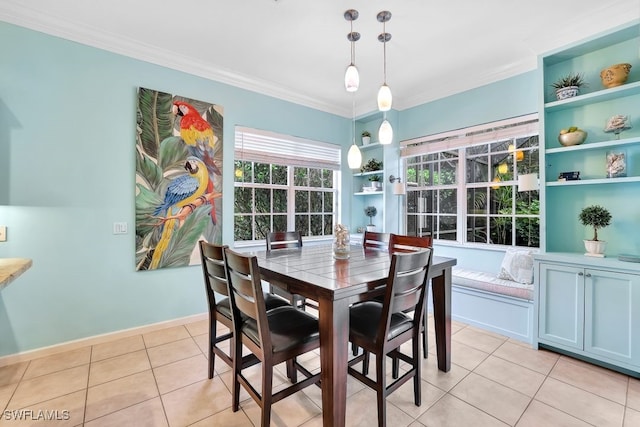 dining space with built in shelves, crown molding, and light tile patterned floors