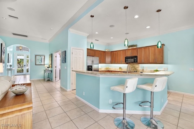 kitchen featuring sink, hanging light fixtures, stainless steel refrigerator with ice dispenser, light tile patterned flooring, and ornamental molding