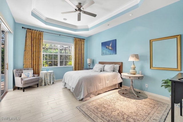 bedroom with access to exterior, light wood-type flooring, ornamental molding, a raised ceiling, and ceiling fan