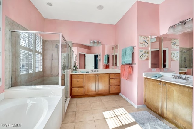 bathroom with plus walk in shower, vanity, and tile patterned flooring