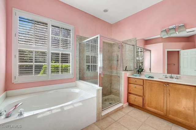 bathroom with tile patterned flooring, vanity, and separate shower and tub